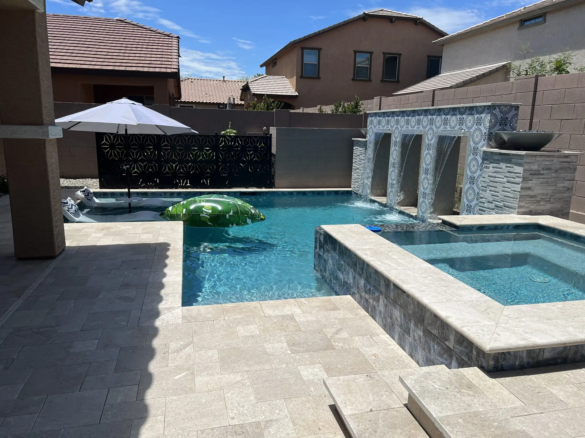 Travertine pool deck with water feature and fire pots, Phoenix