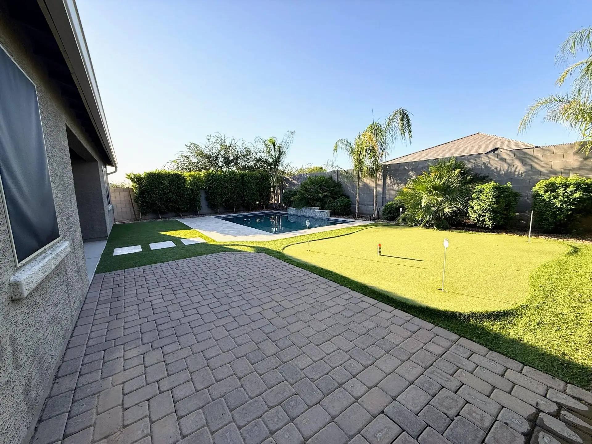 Queen Creek AZ backyard with artificial turf, putting green, and swimming pool.