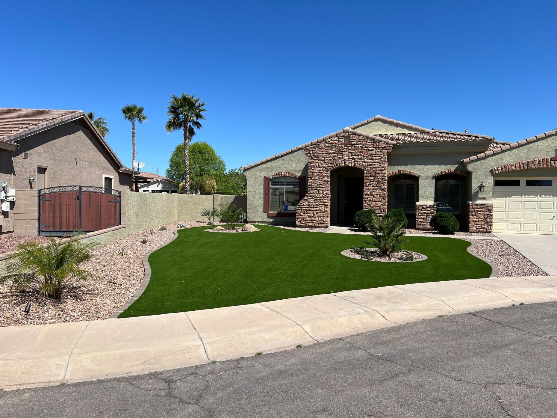 Finished Chandler front yard with artificial turf and circular palm planter