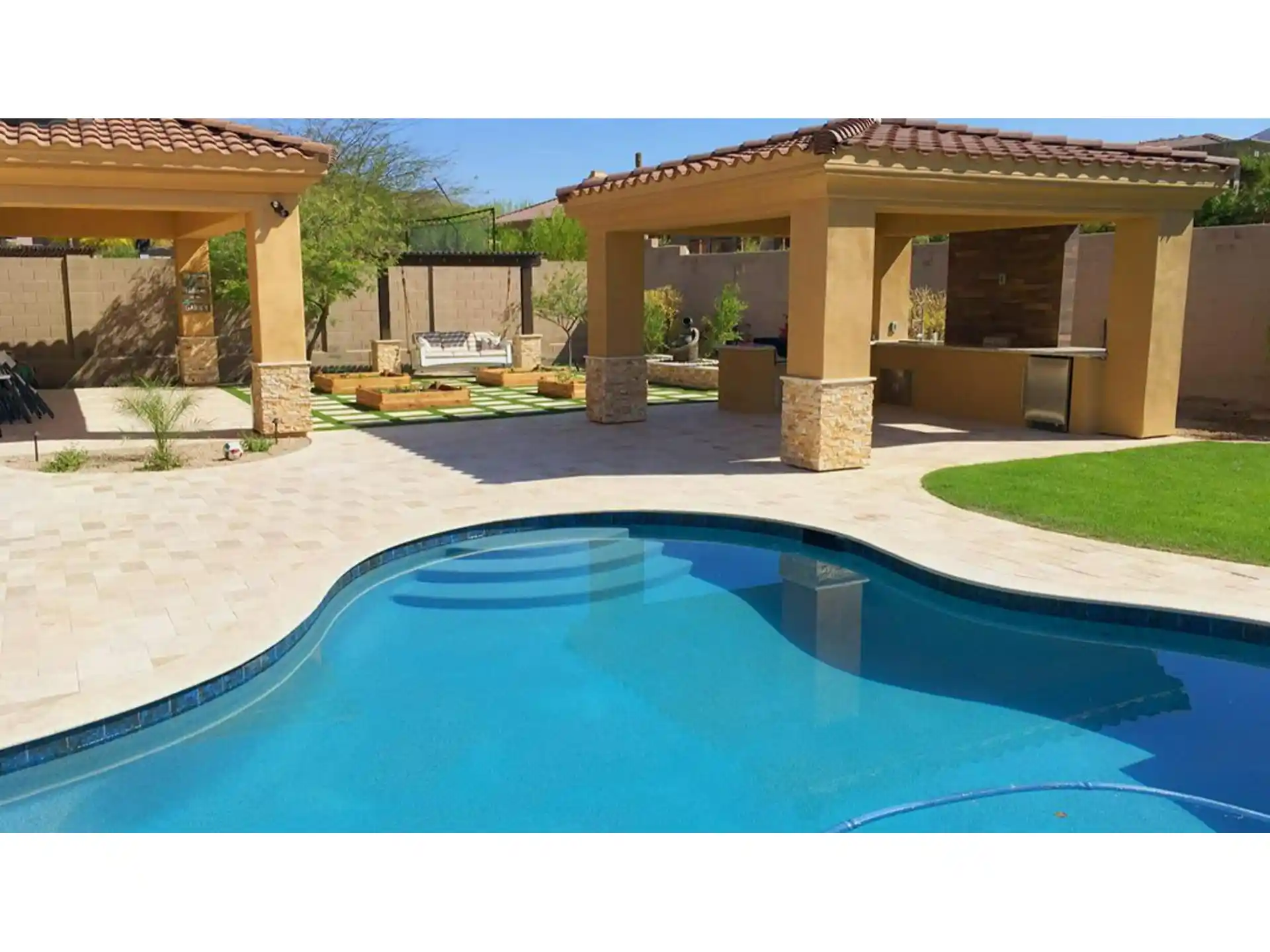 Backyard remodel featuring a renovated pool area with modern landscaping, outdoor seating, and shaded structures, showcasing a transformation into an inviting retreat.