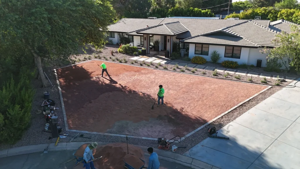 Dream Retreats crew screeding the compacted base course before artificial turf installation in Phoenix, AZ